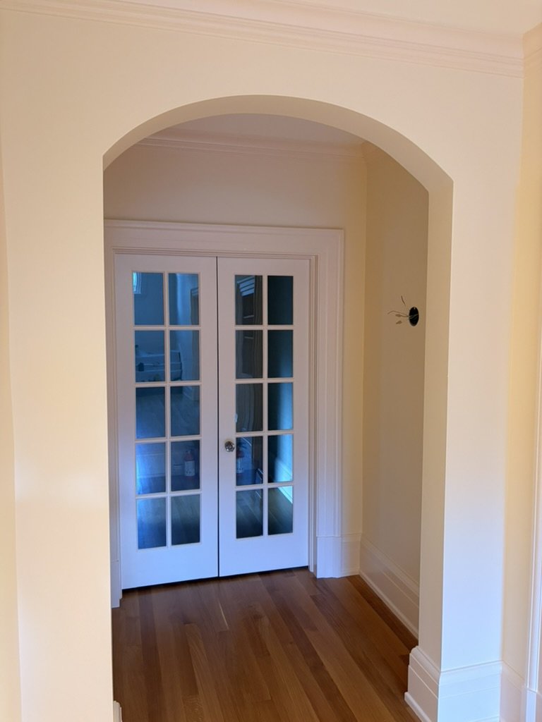 Painted archway leading to white French doors
