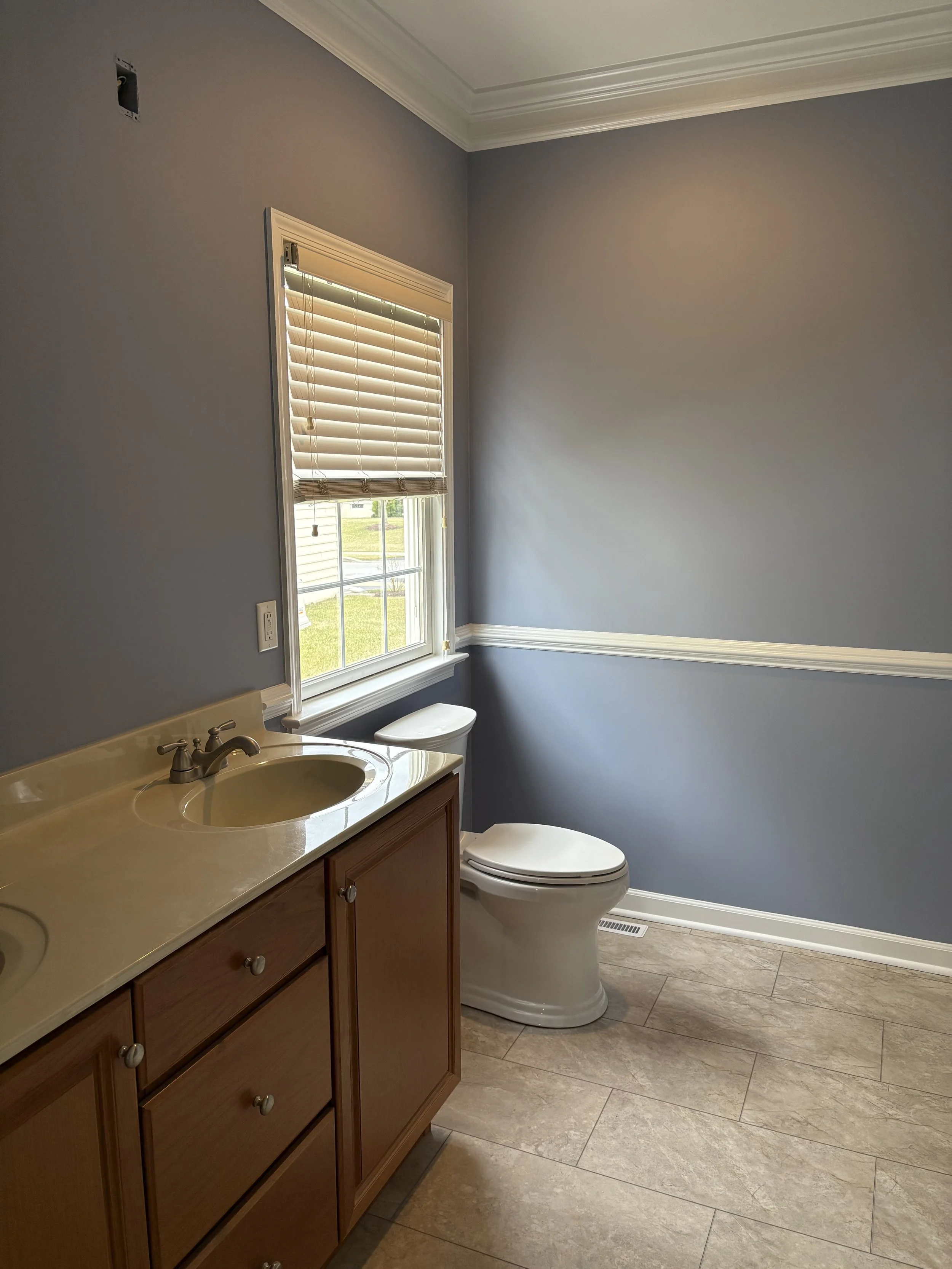 Bathroom painted soft purple-gray with white trim