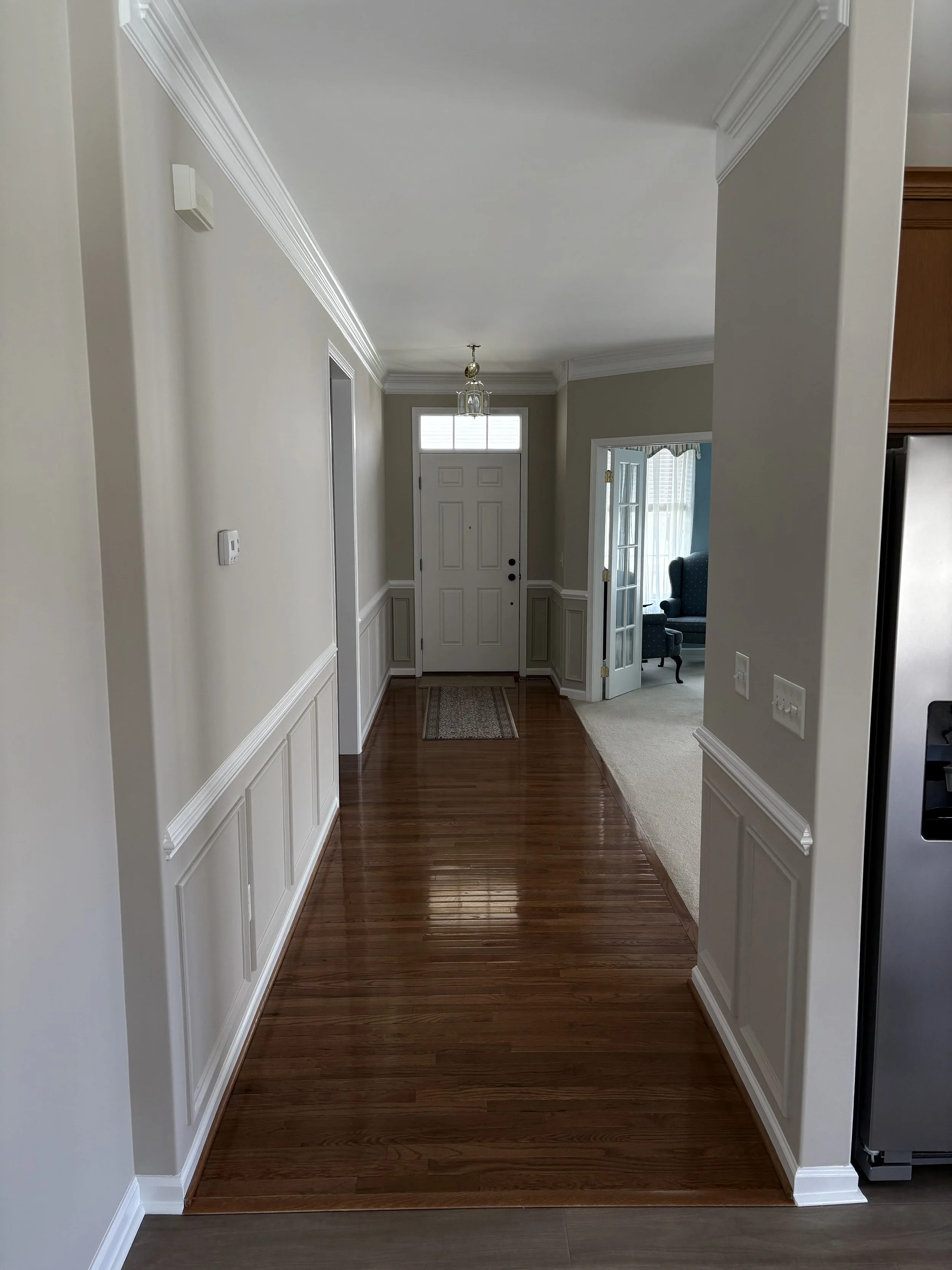 Freshly painted hallway with neutral walls and crisp white trim